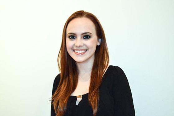 Photo of a smiling Chatham University female student standing in front of a white background